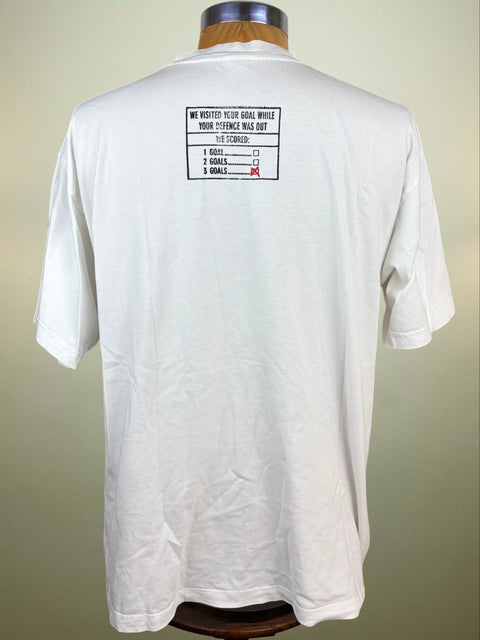 A white short-sleeve t-shirt displayed on a wooden dress form, showing the back of the garment with a black and red graphic print on the upper back.