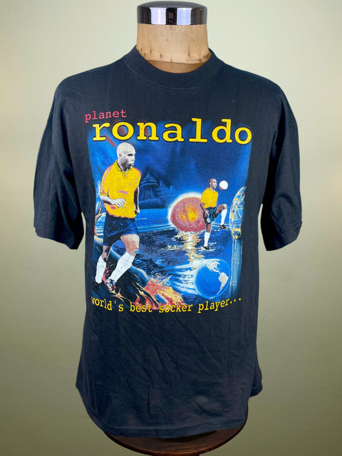 Black t-shirt with 'planet ronaldo' graphic on a mannequin against a beige background