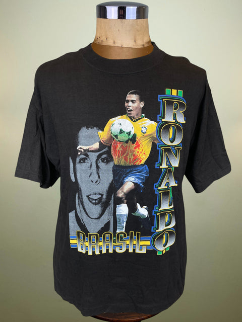Black t-shirt with a graphic of a soccer player and 'Ronaldo' text on a mannequin against a beige background
