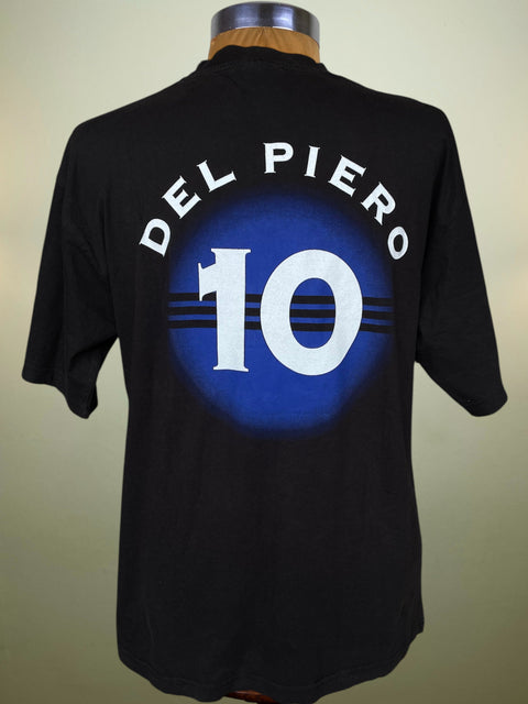 A black short-sleeve t-shirt displayed on a mannequin torso, showing the back graphic with the text 'DEL PIERO' in white arched above a large white '10' over a blue circular design.