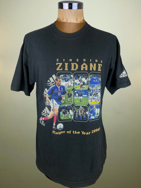 Black t-shirt with Zinedine Zidane graphics and Adidas logo on a mannequin against a beige background