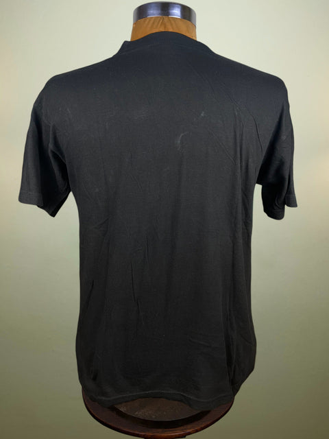 Black t-shirt on a mannequin against a beige background