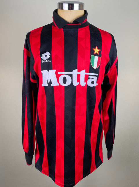 A long-sleeved black and red striped AC Milan jersey with 'Motta' branding on the chest and the Italian national team's crest on the left chest.