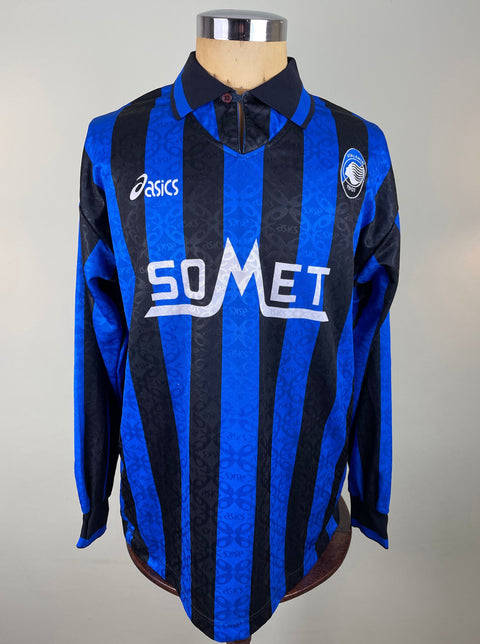 A long-sleeved Atalanta 1995-96 jersey with a blue and black checkered pattern, made by Asics featuring the sponsor SoMet