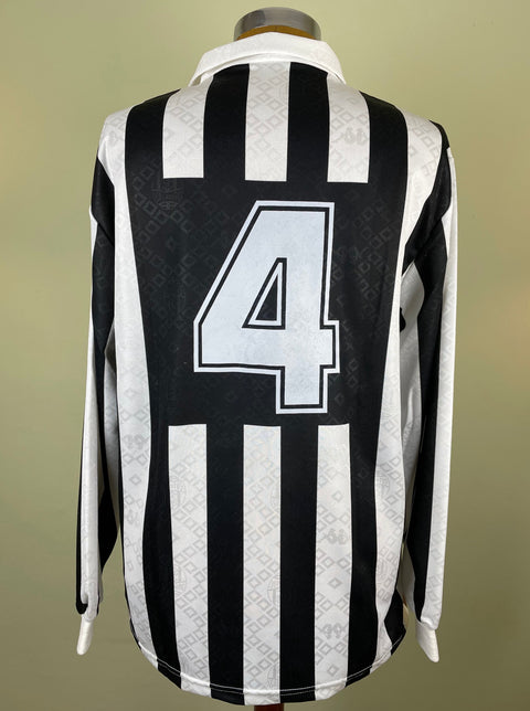 A black and white striped match worn Antonio Conte Juventus soccer jersey featuring long sleeves and a V-neck collar with number 4 painted on the back.