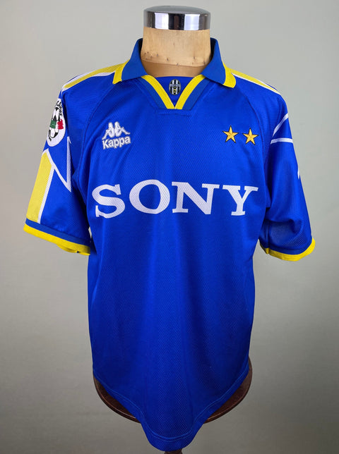 A blue Juventus 1996-97 match worn Away jersey with the number 21 and the name ZIDANE on the back in yellow and white text.