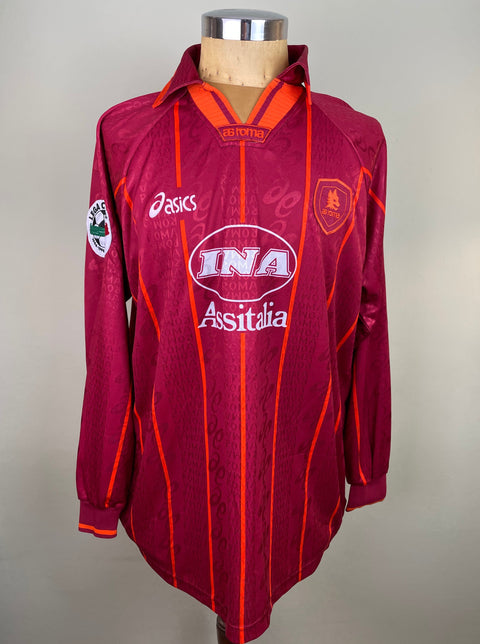Maroon AS Roma 1996/97 home shirt, long sleeves, INA Assitalia sponsor across the chest. Match-worn and signed by Aldair. Asics logo.